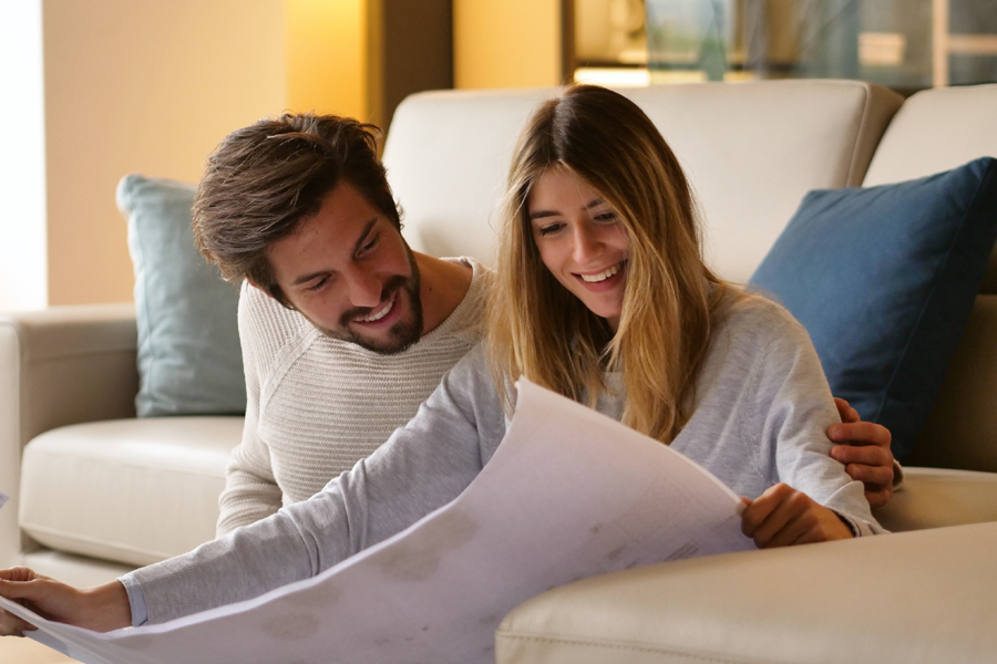 couple reviewing plans for new house after obtaining a home equity loan