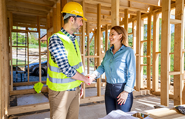 woman meeting with builder at custom home build location