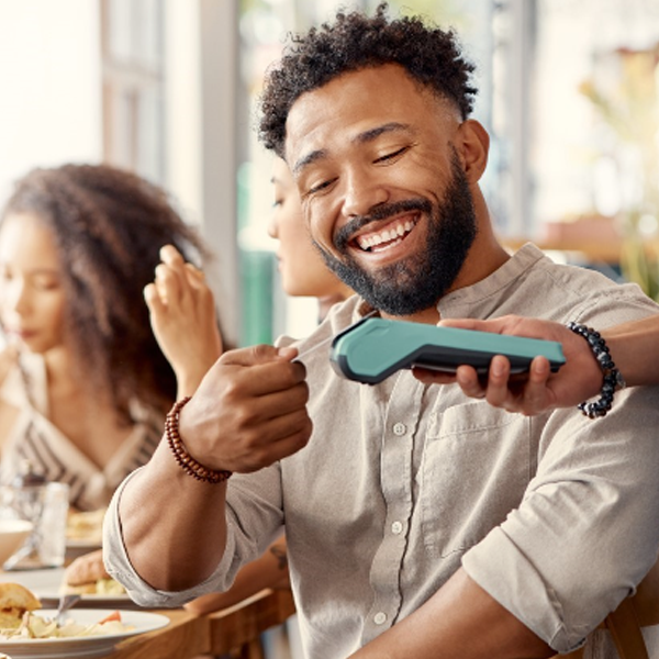 Man using his debit card while dining out