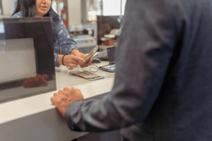 Man receiving cash from bank teller