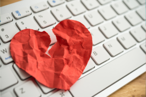 broken paper heart on a keyboard