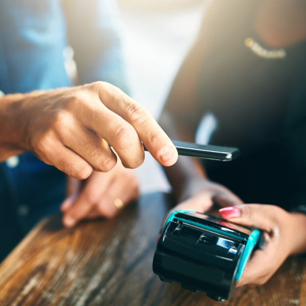 man using digital wallet to pay bill at restaurant