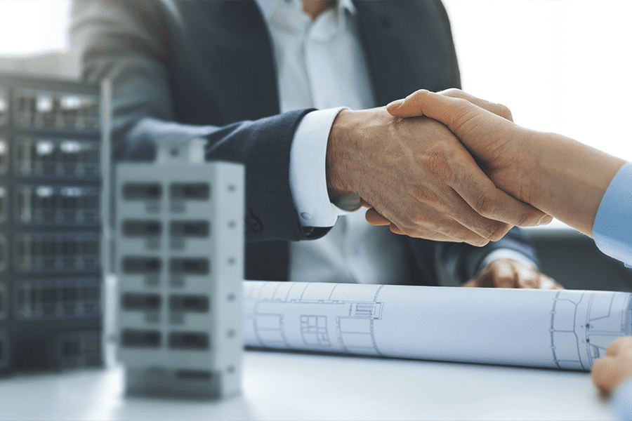 business people shaking hands about commercial real estate investments