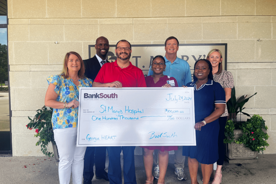 BankSouth representatives present a $100,000 donation check to Bria Brown of St. Mary's Good Samaritan Hospital, supporting rural healthcare through the Georgia HEART program.