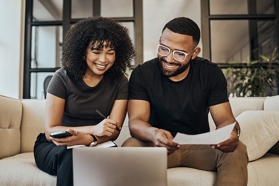 couple considering checking account options looking at a computer