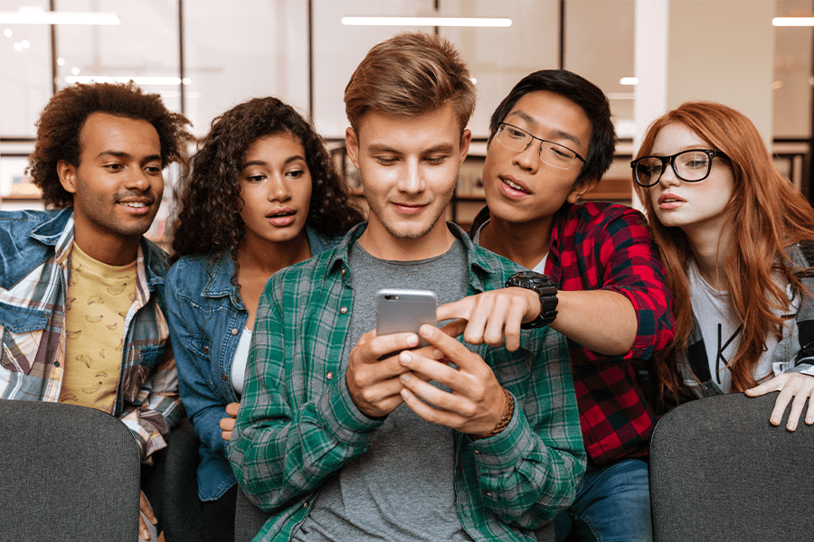 young adults looking at a mobile phone