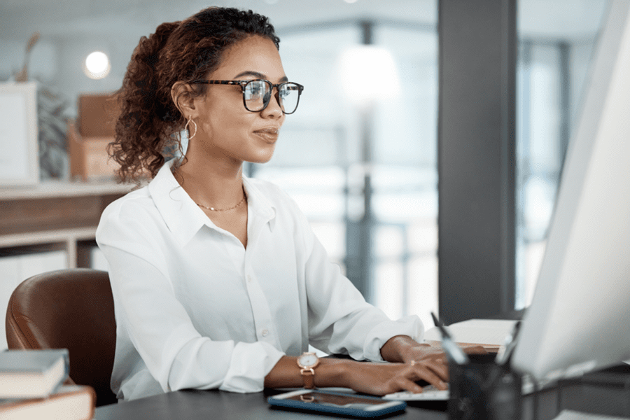 business woman facing right working at a computer in an office